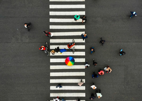 A zebra crossing with pedestrians crossing over